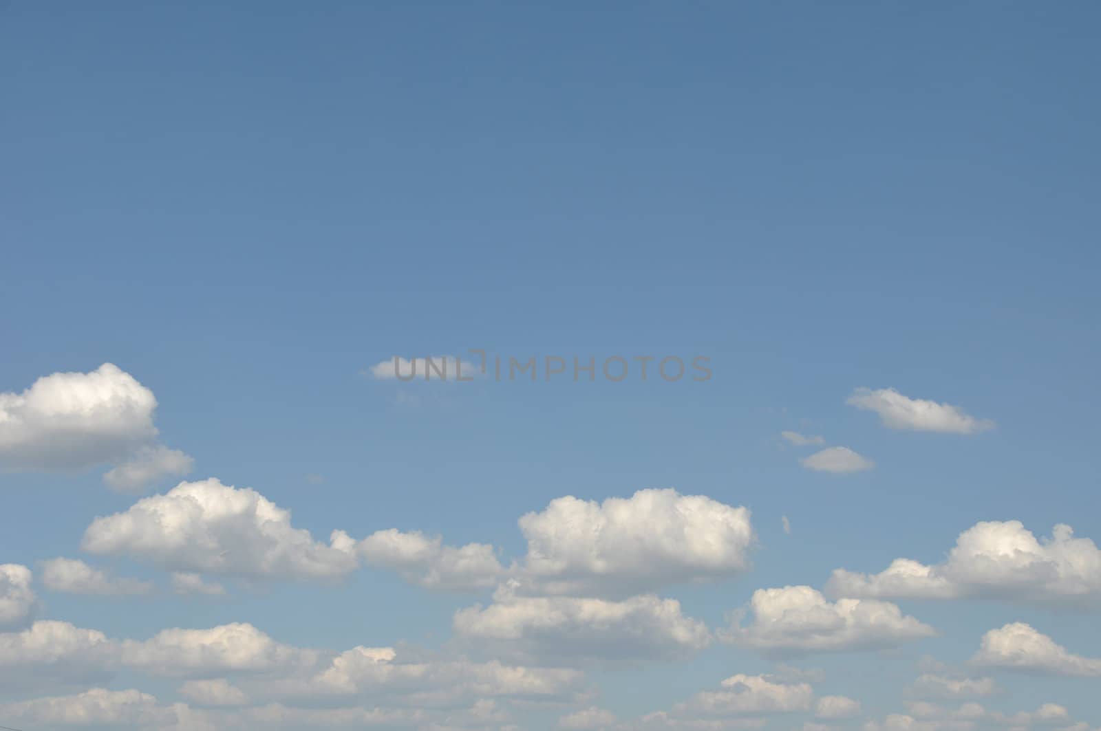 gorgeous white clouds in the blue sky (copy-space available at the top)