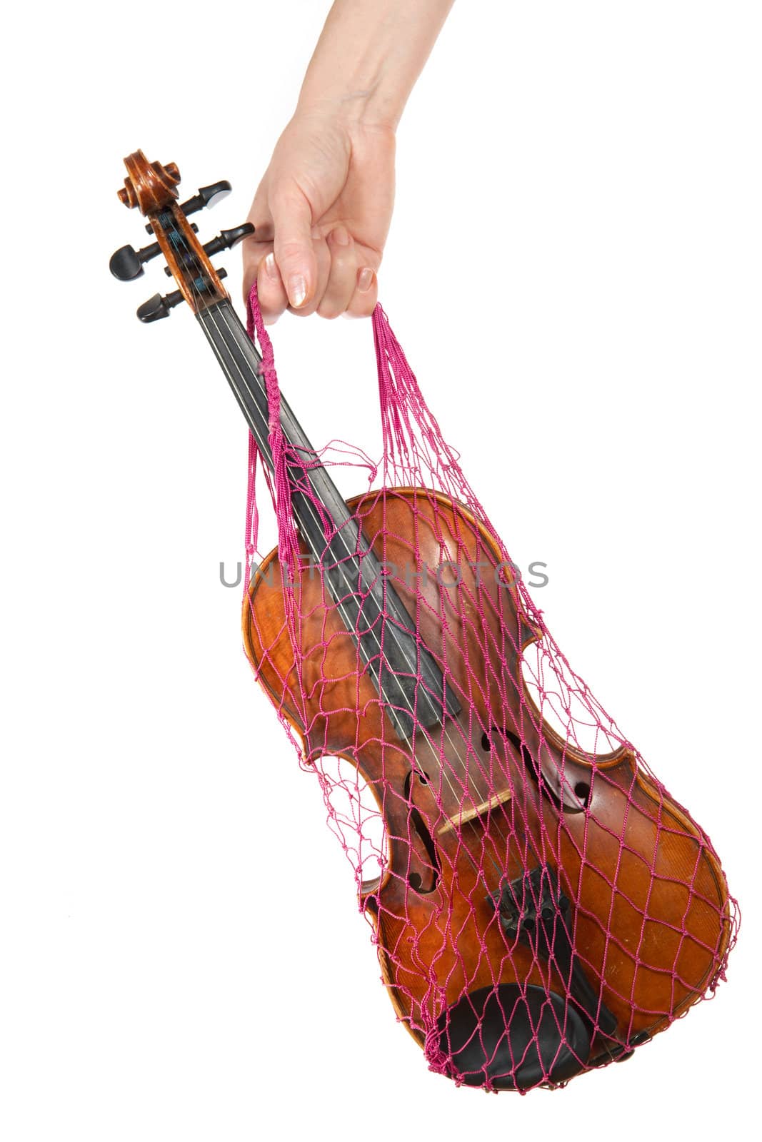Female hand holding a red mesh with the violin, isolated, on a white background