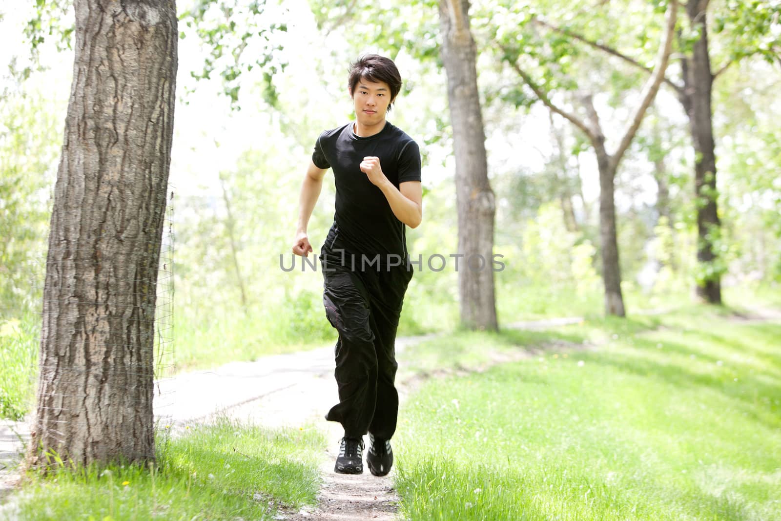 Portrait of man running in a park by leaf