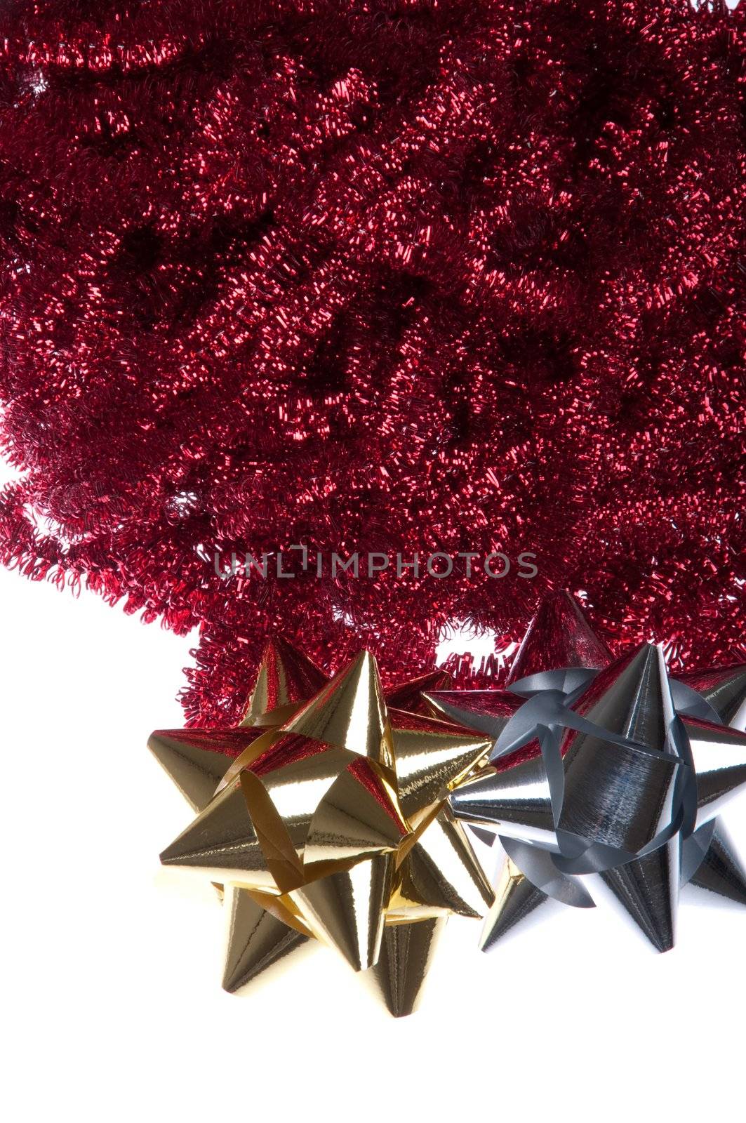 Christmas time with tinsel decorations and vibrant gift bows isolated on white background