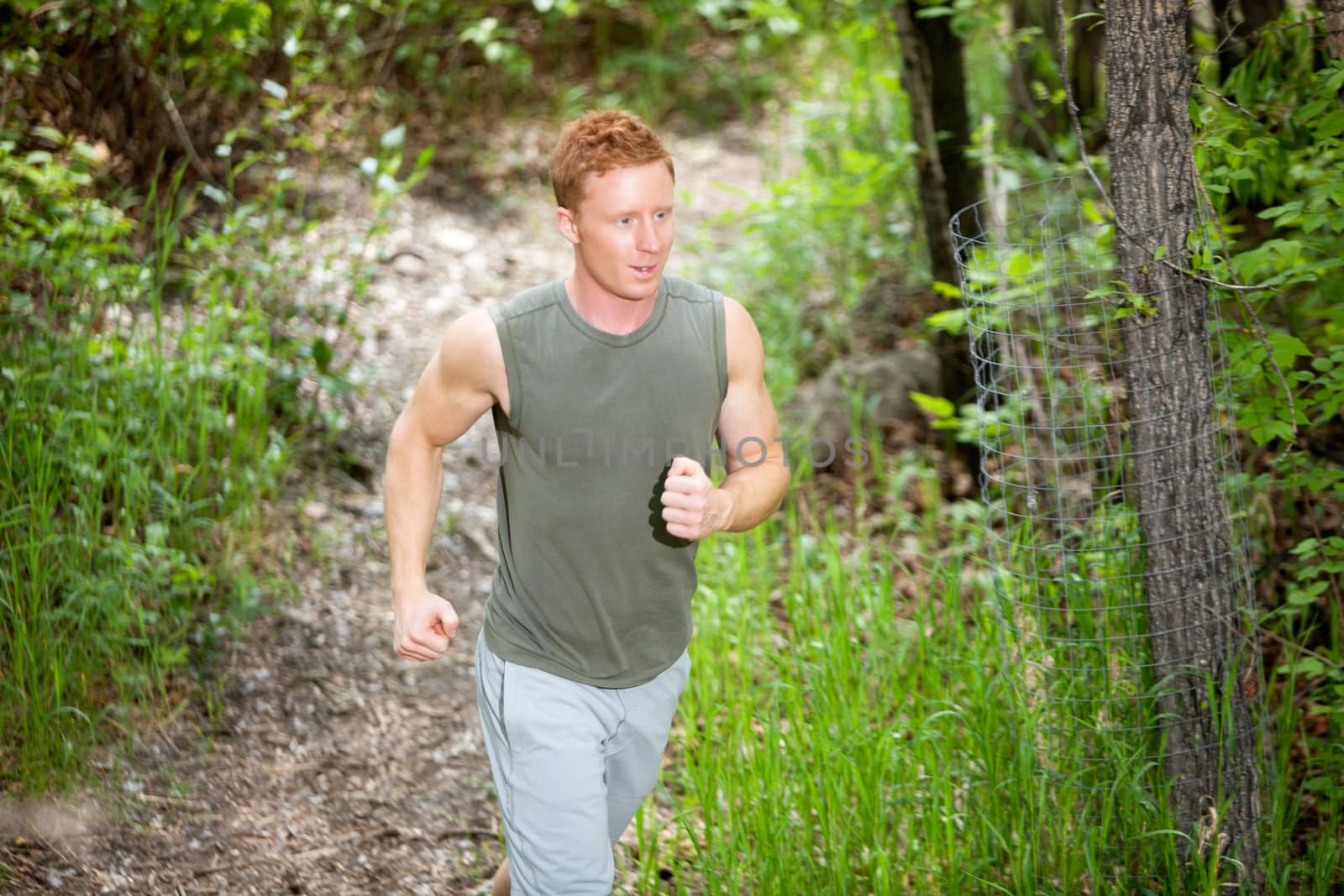 Young man jogging by leaf