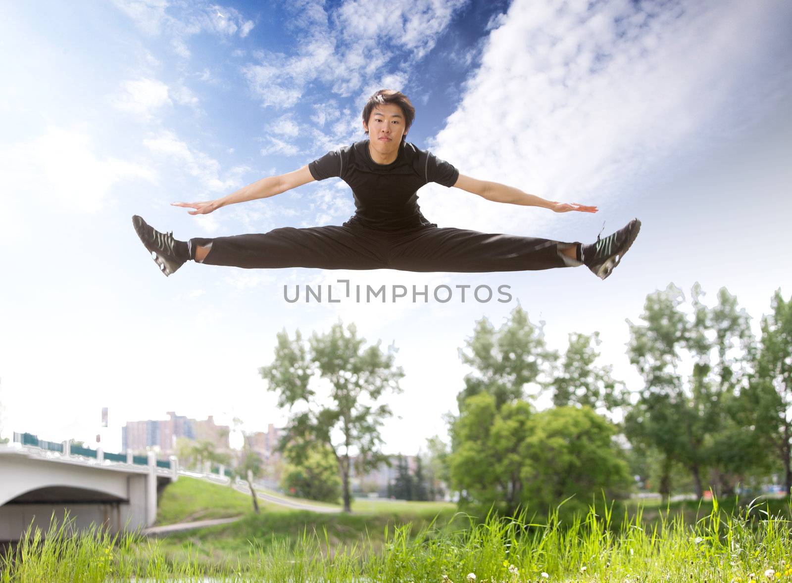 Man jumping in the air by leaf