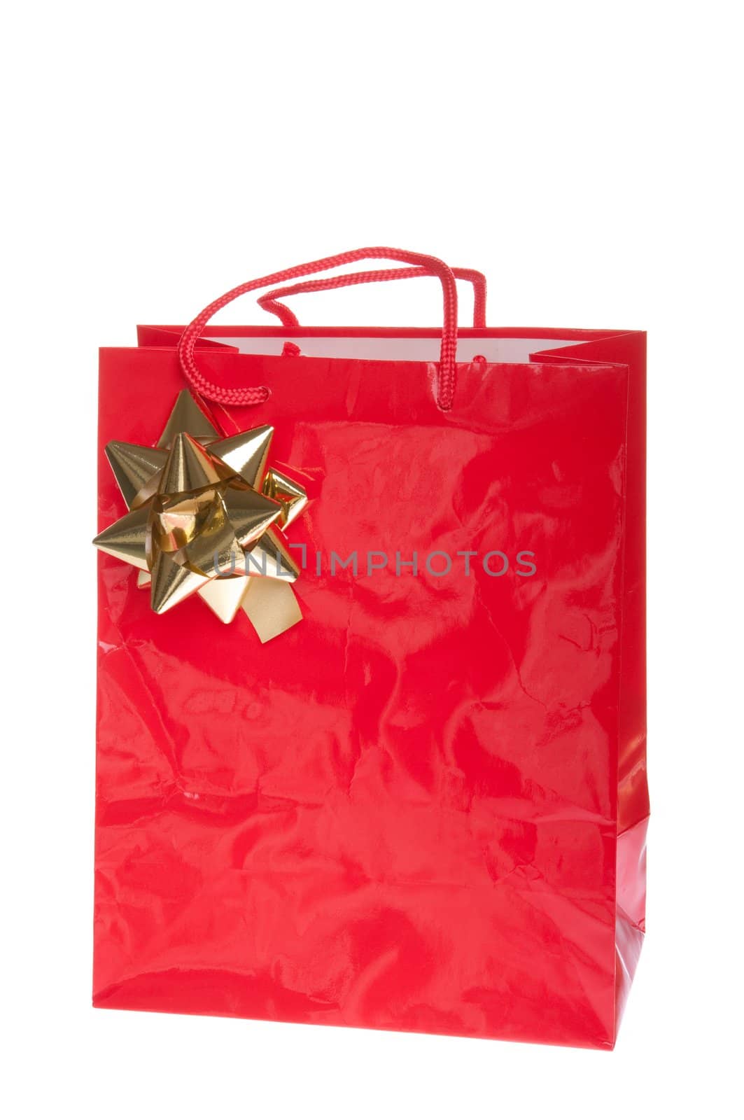 red gift paper bag with golden bow isolated on white background