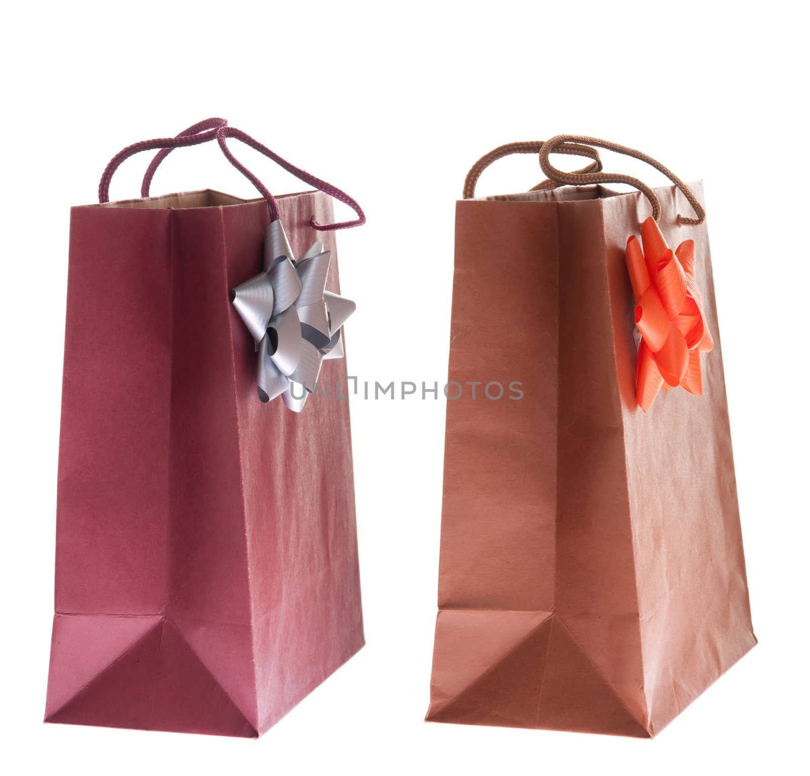 two colorful gift paper bags with bows isolated on white background