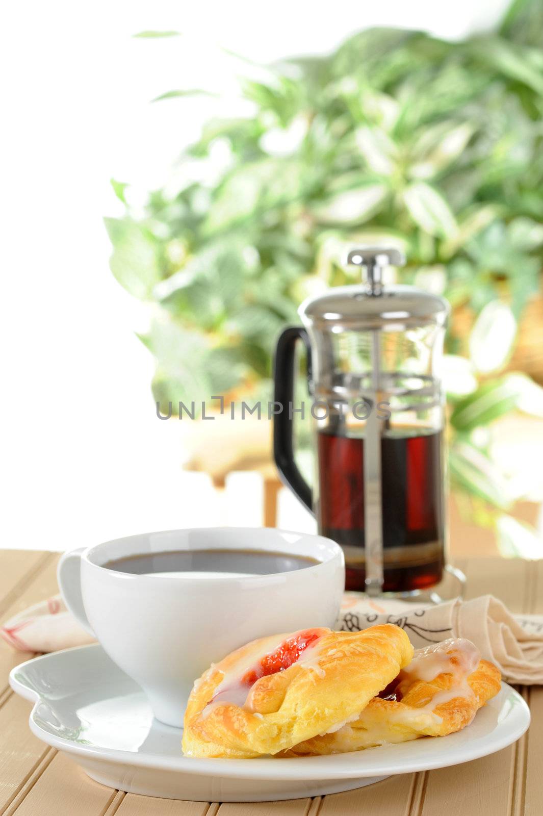 Fresh cherry danish served with black coffee.