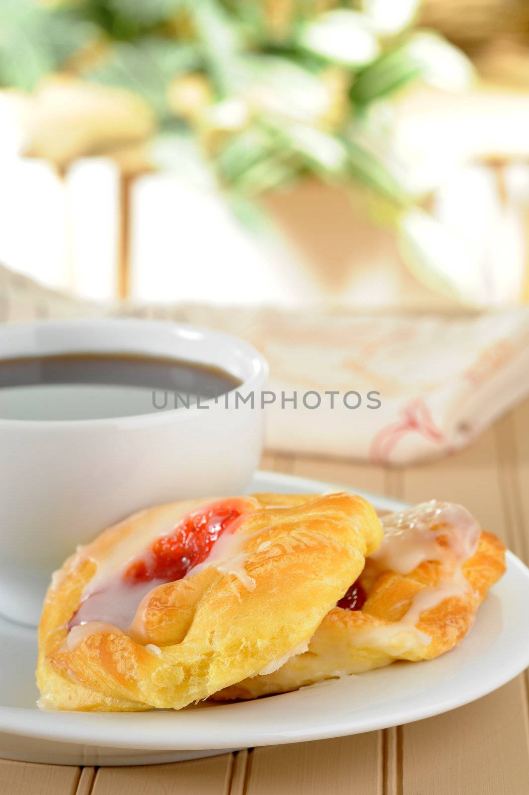 Fresh cherry danish served with black coffee.