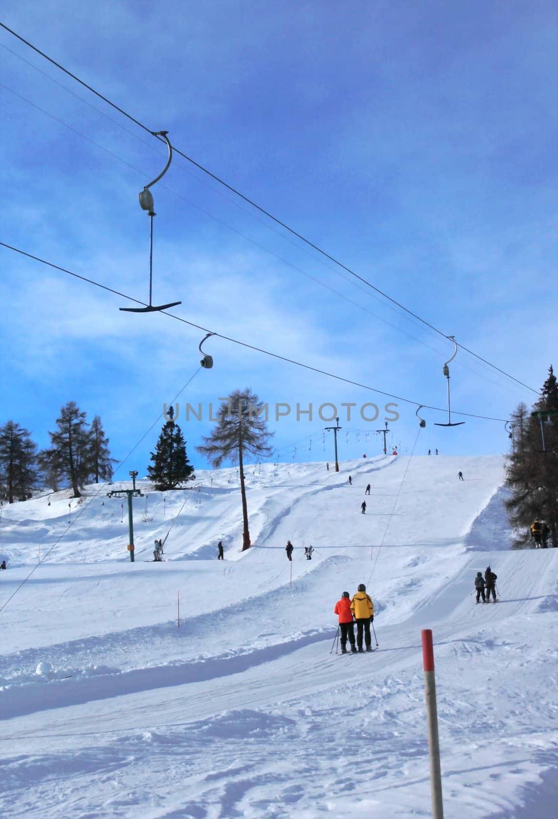 People using ski tow in the winter Alps mountain by beautiful weather, Switzerland