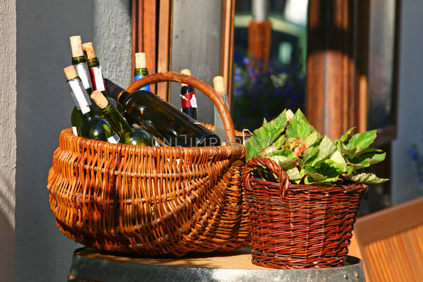 Restaurant exhibition. Two baskets with bottles of wine and salads