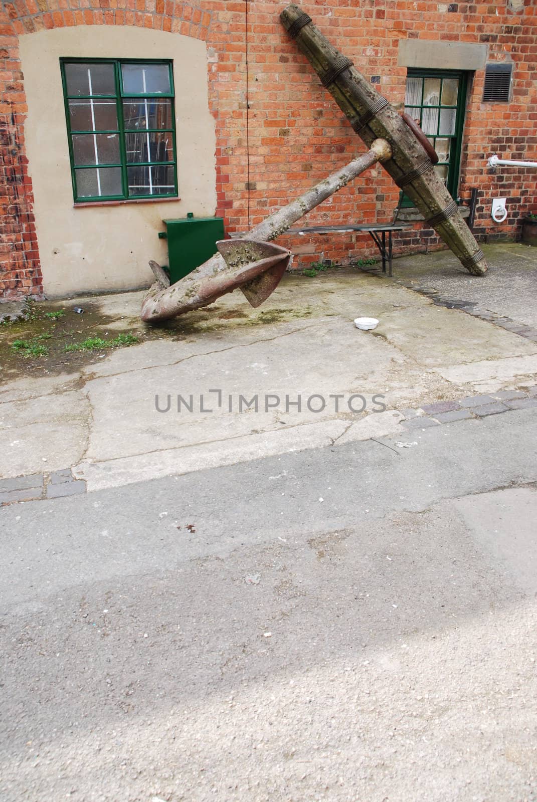 old and heavy anchor used to attach a ship to the bottom of the sea