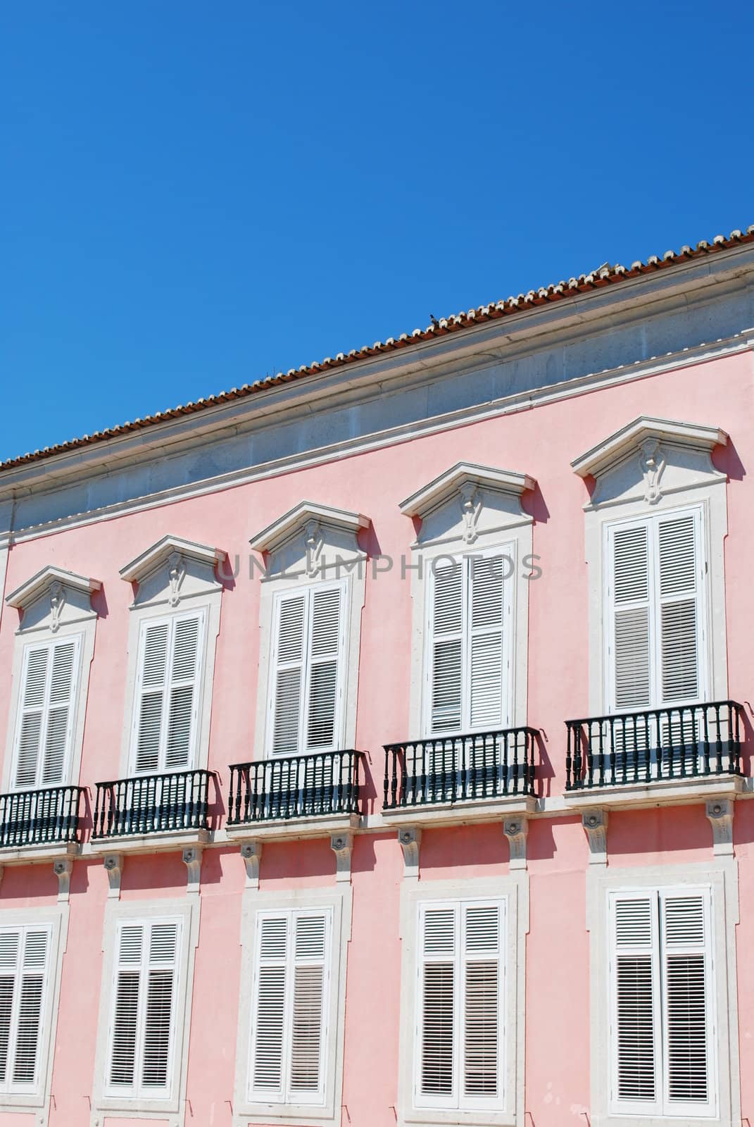 photo of a ancient and residential pink building