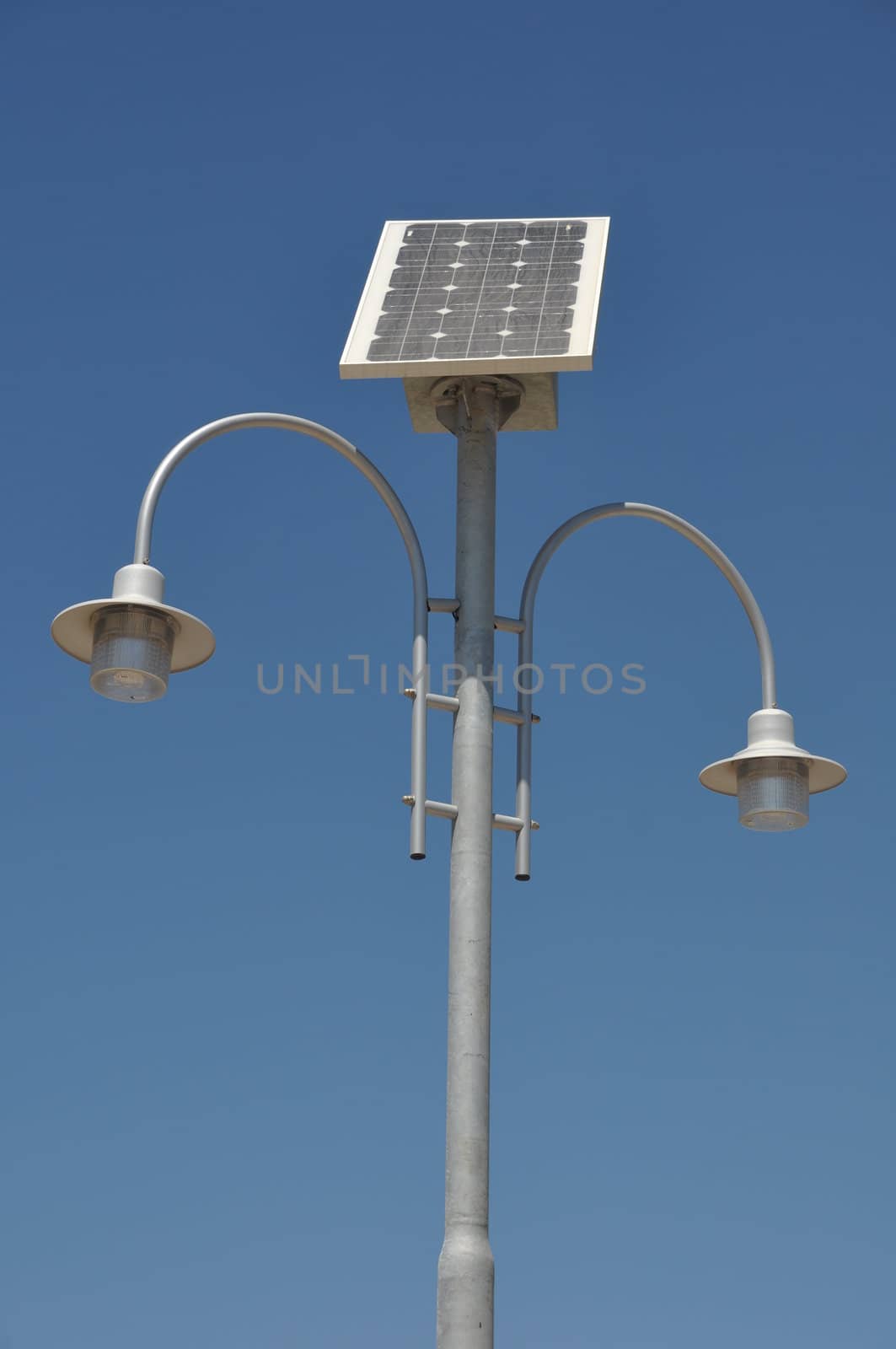 street lamp post with solar panel energy (against blue sky background)