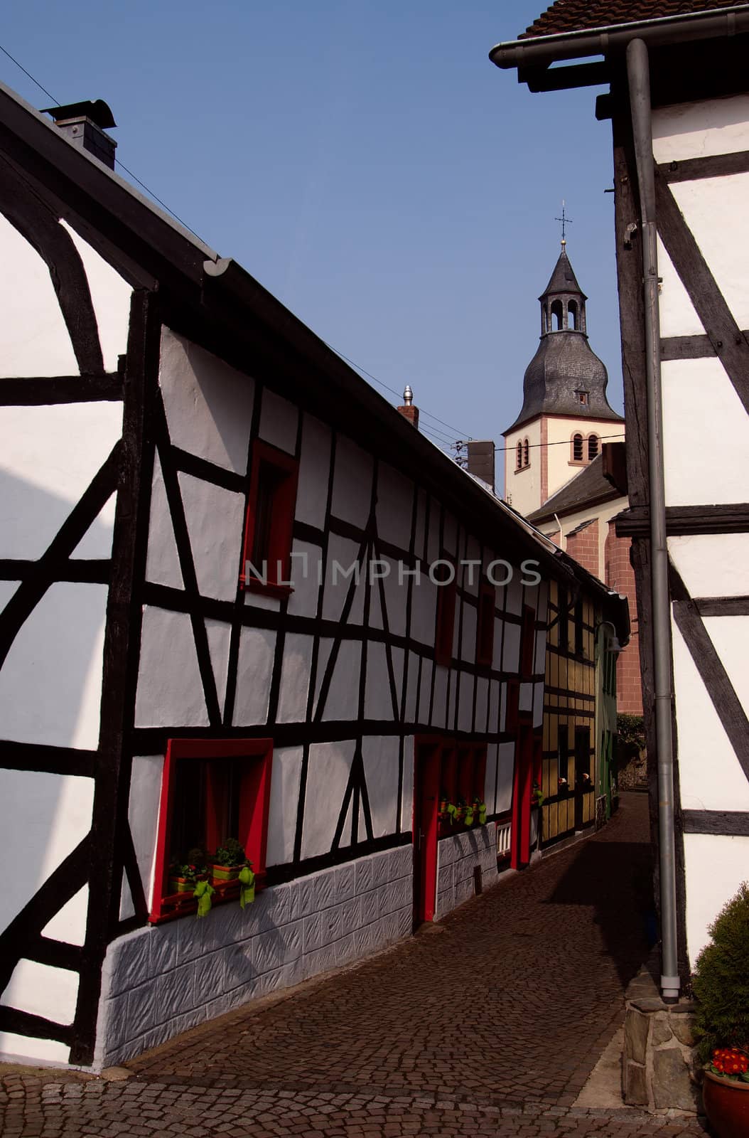 Traditional old house and church in town Heimbach, Germany