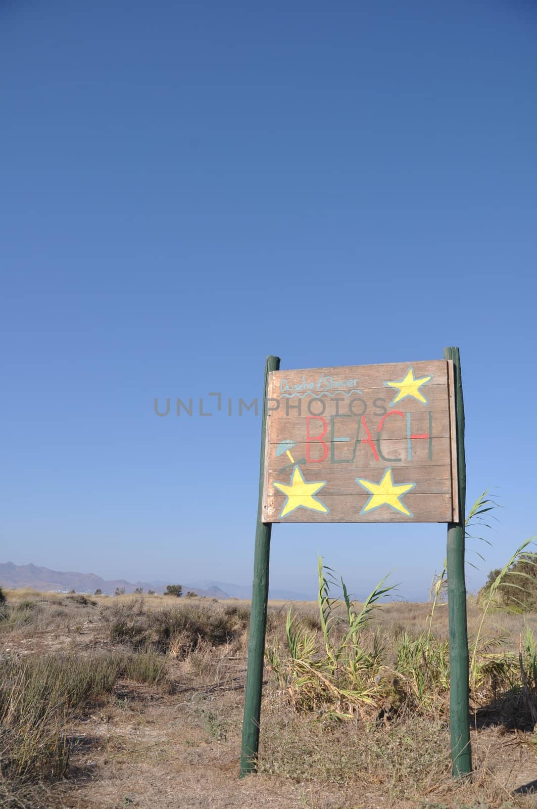 beach wooden sign at Kos island, Greece (blue sky background)