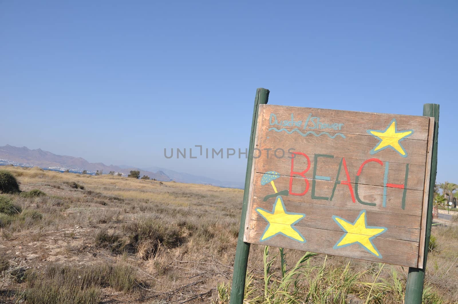 beach wooden sign at Kos island, Greece (blue sky background)