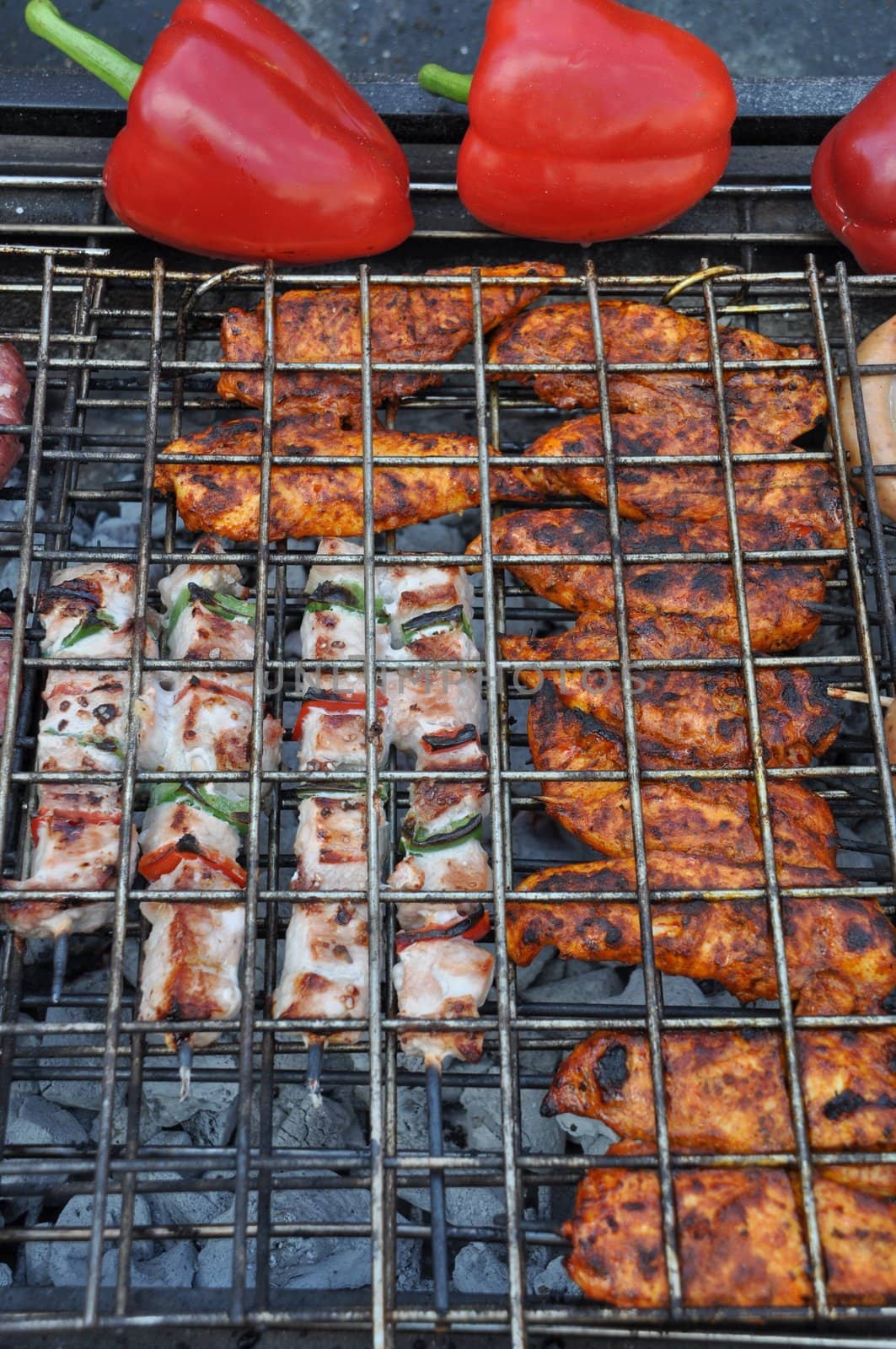 grilling fresh meat and peppers on a outdoor barbecue