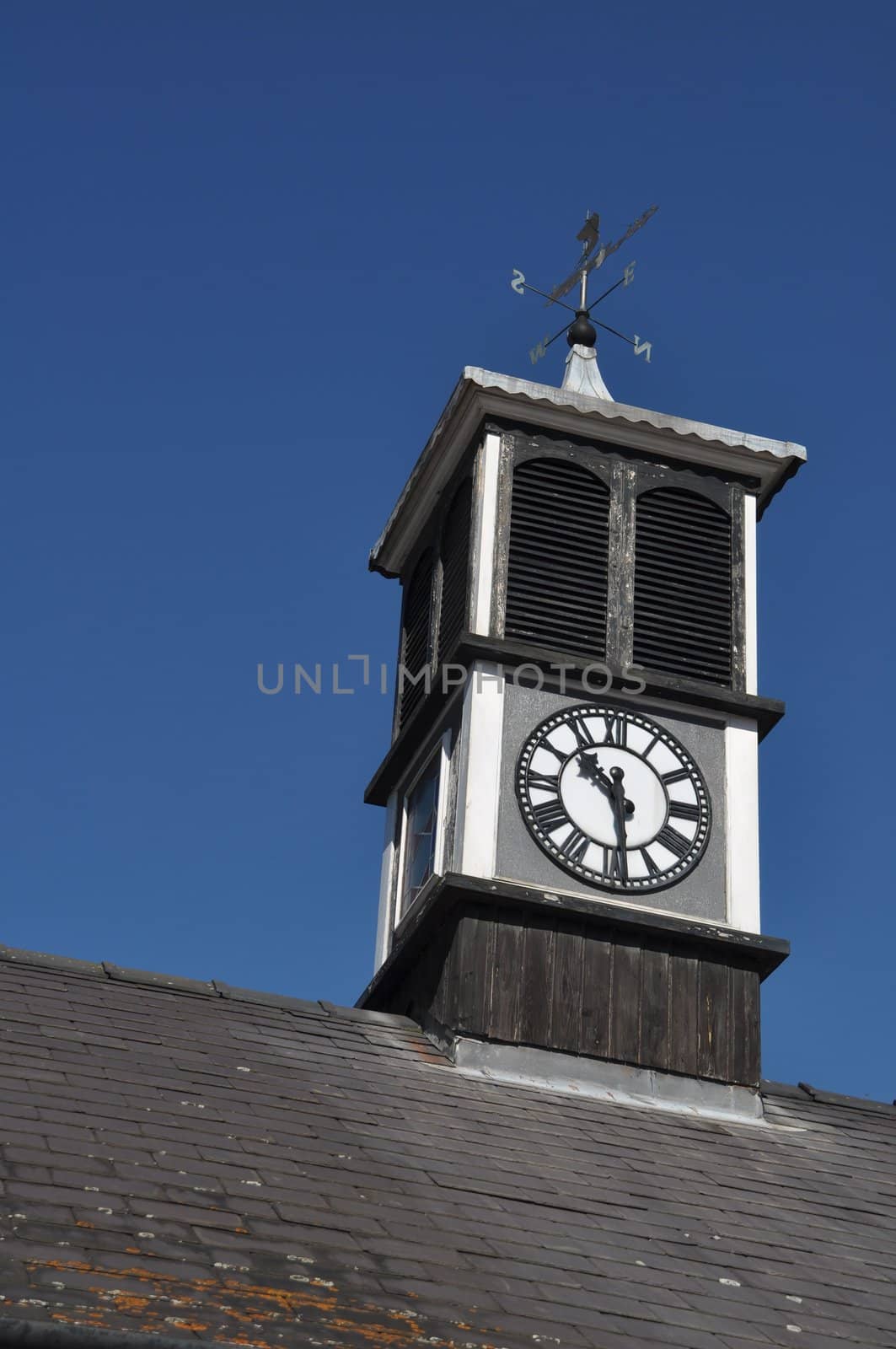 clock tower with weather vane on top of a building in Gloucester, England