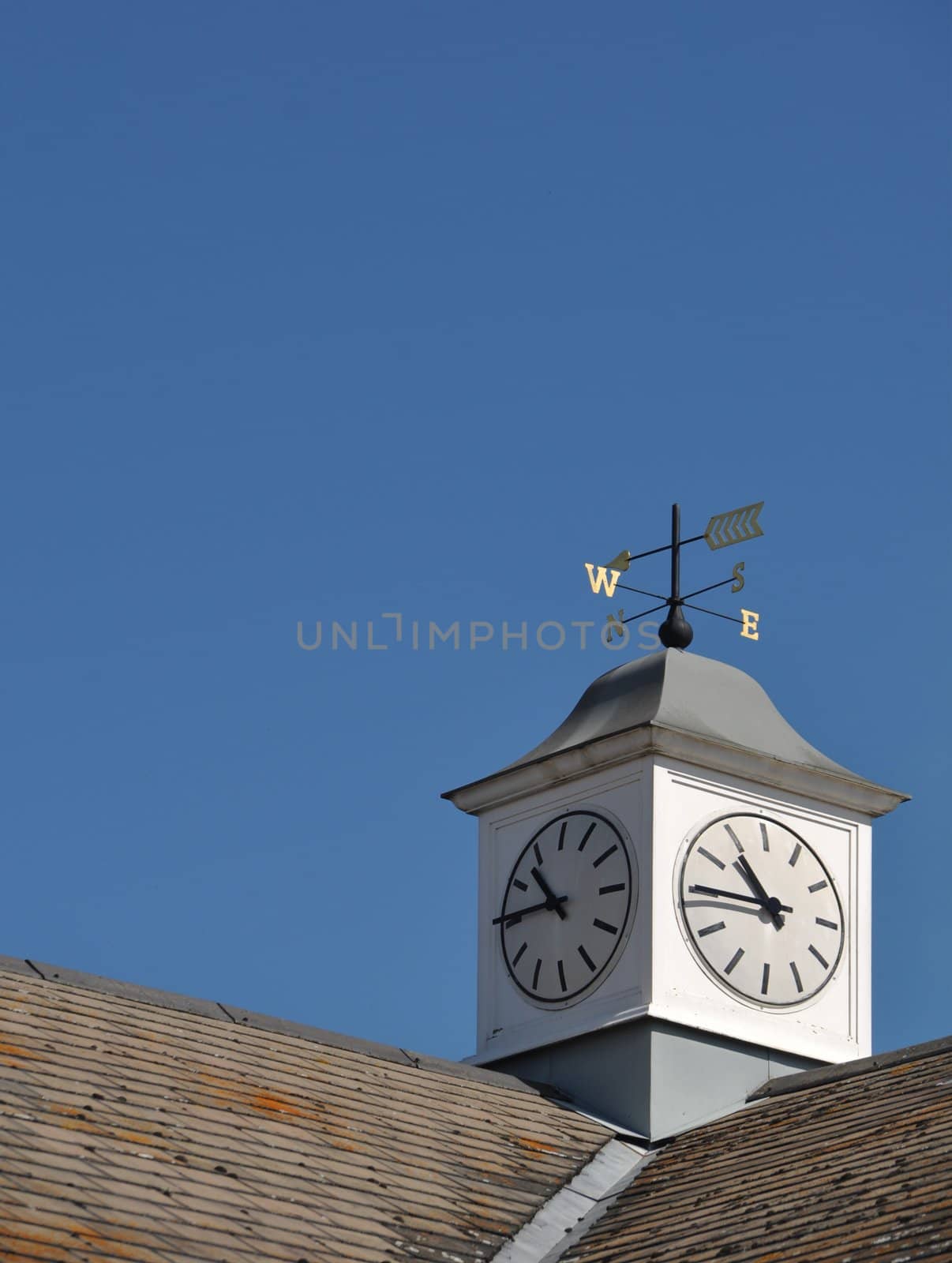 clock tower with weather vane on top of a building in Gloucester, England