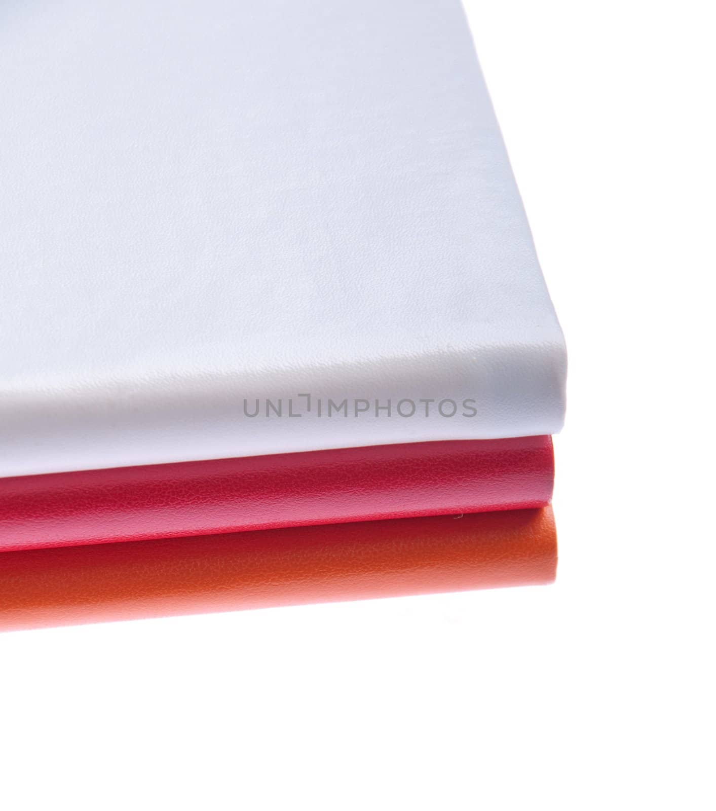 pile of colored notebooks (isolated on white background)