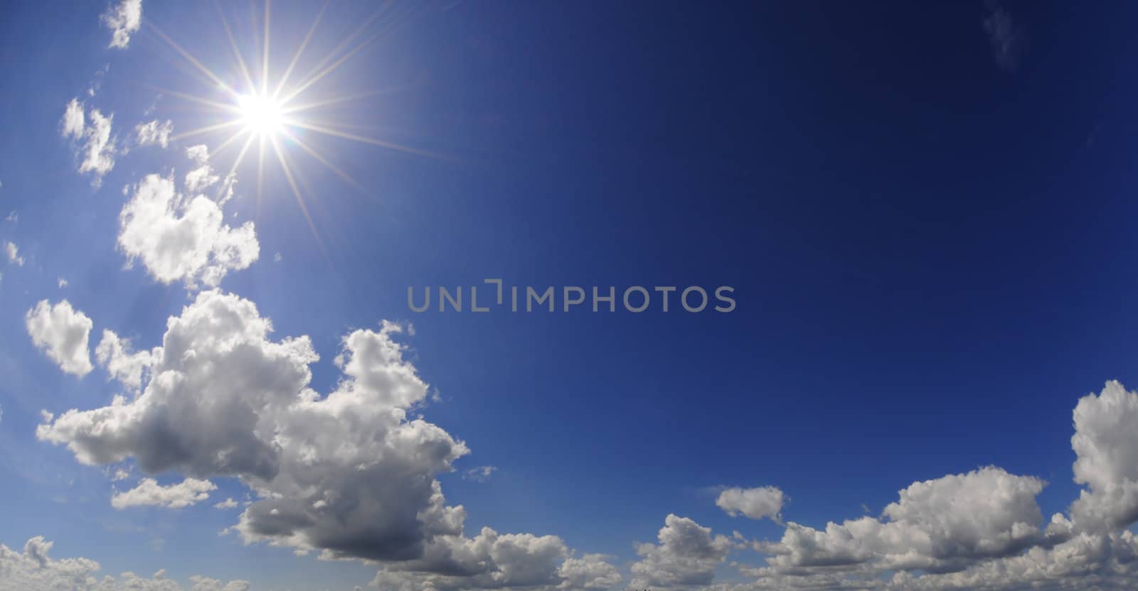 Blue sky with sbright shining sun and white clouds
