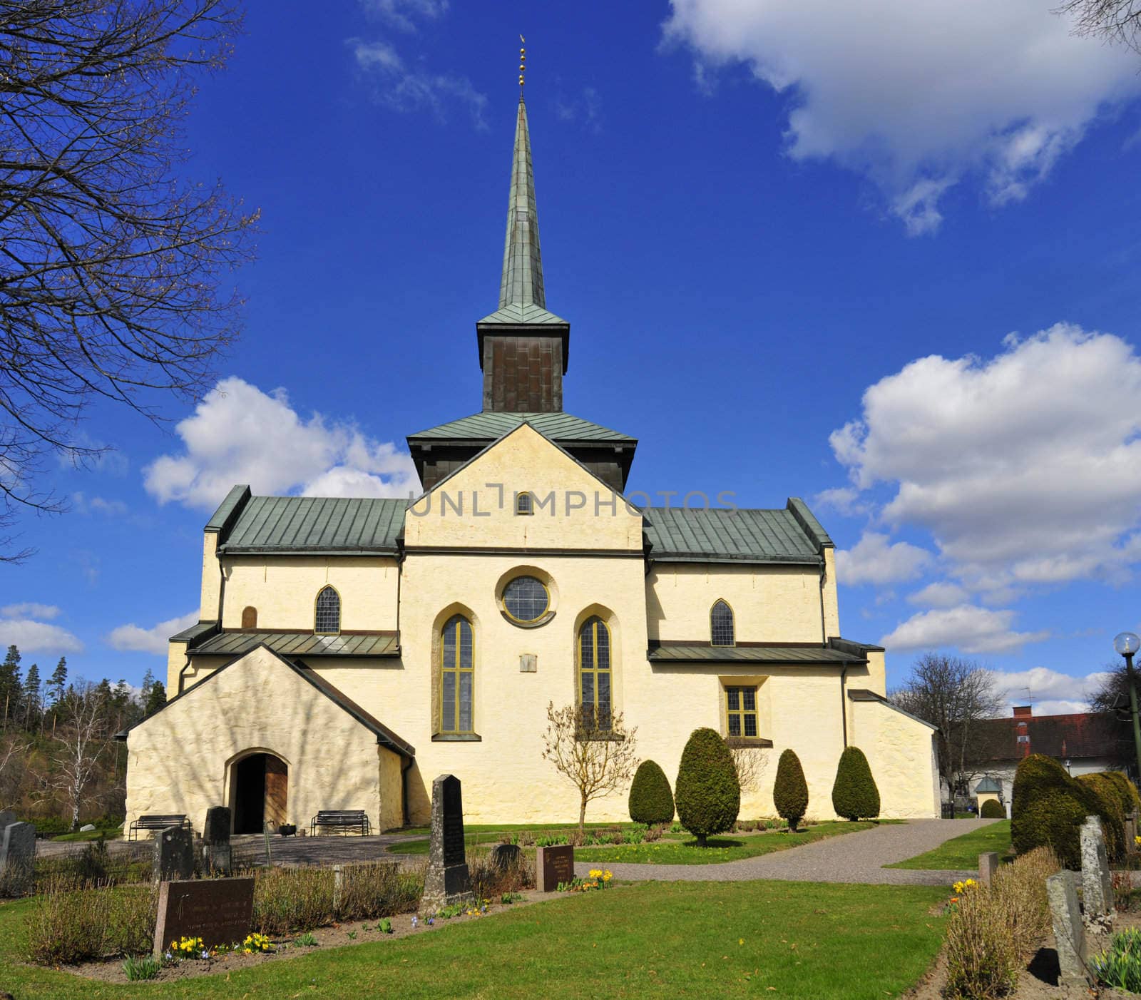 Beautiful Swedish church with perfect blue sky and white clouds