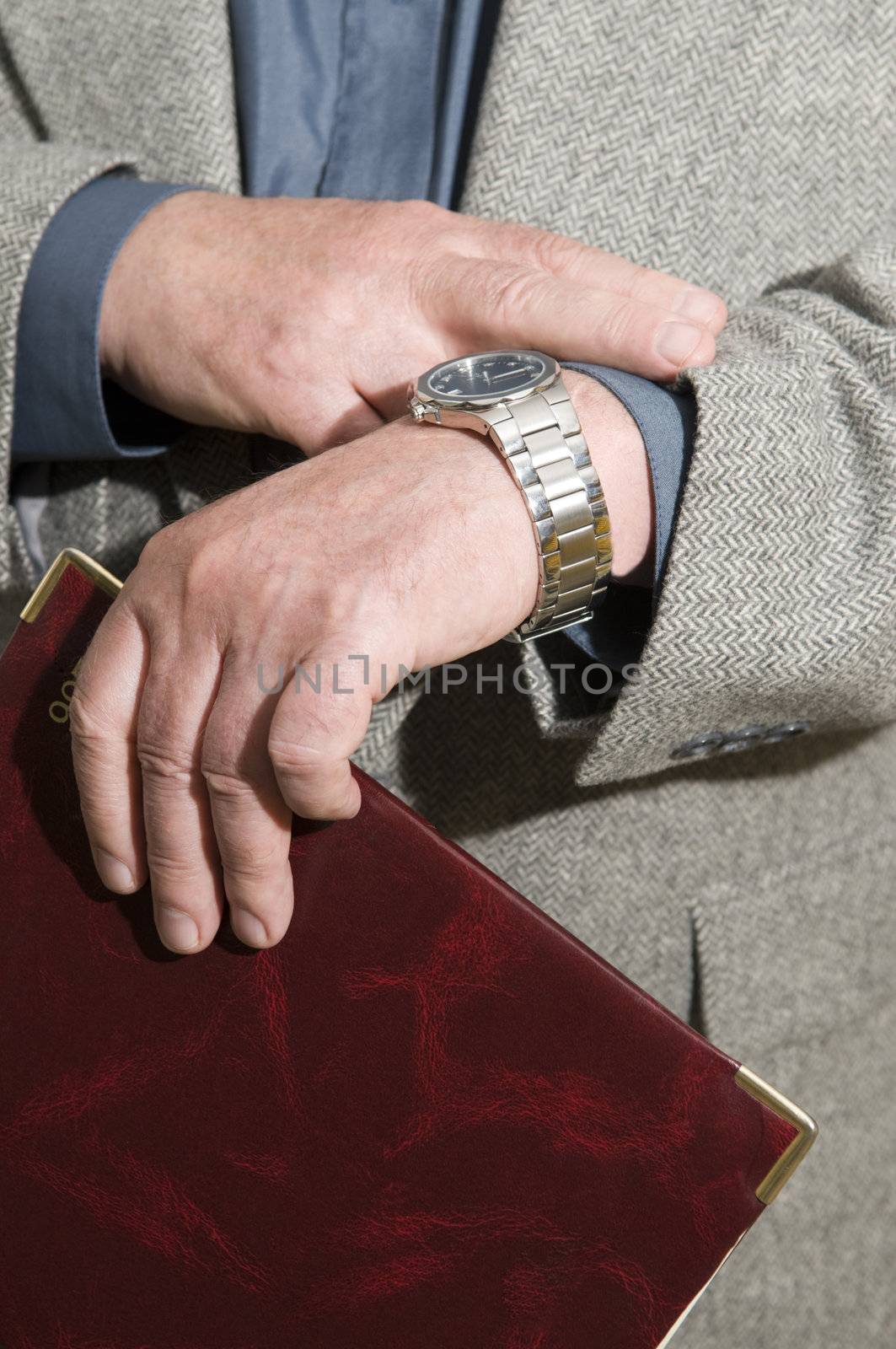 
 	
The businessman looks at the watch checks the amount of time left before the meeting