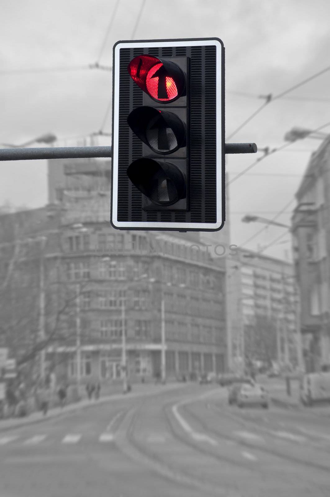 Red color on the traffic light against city background
