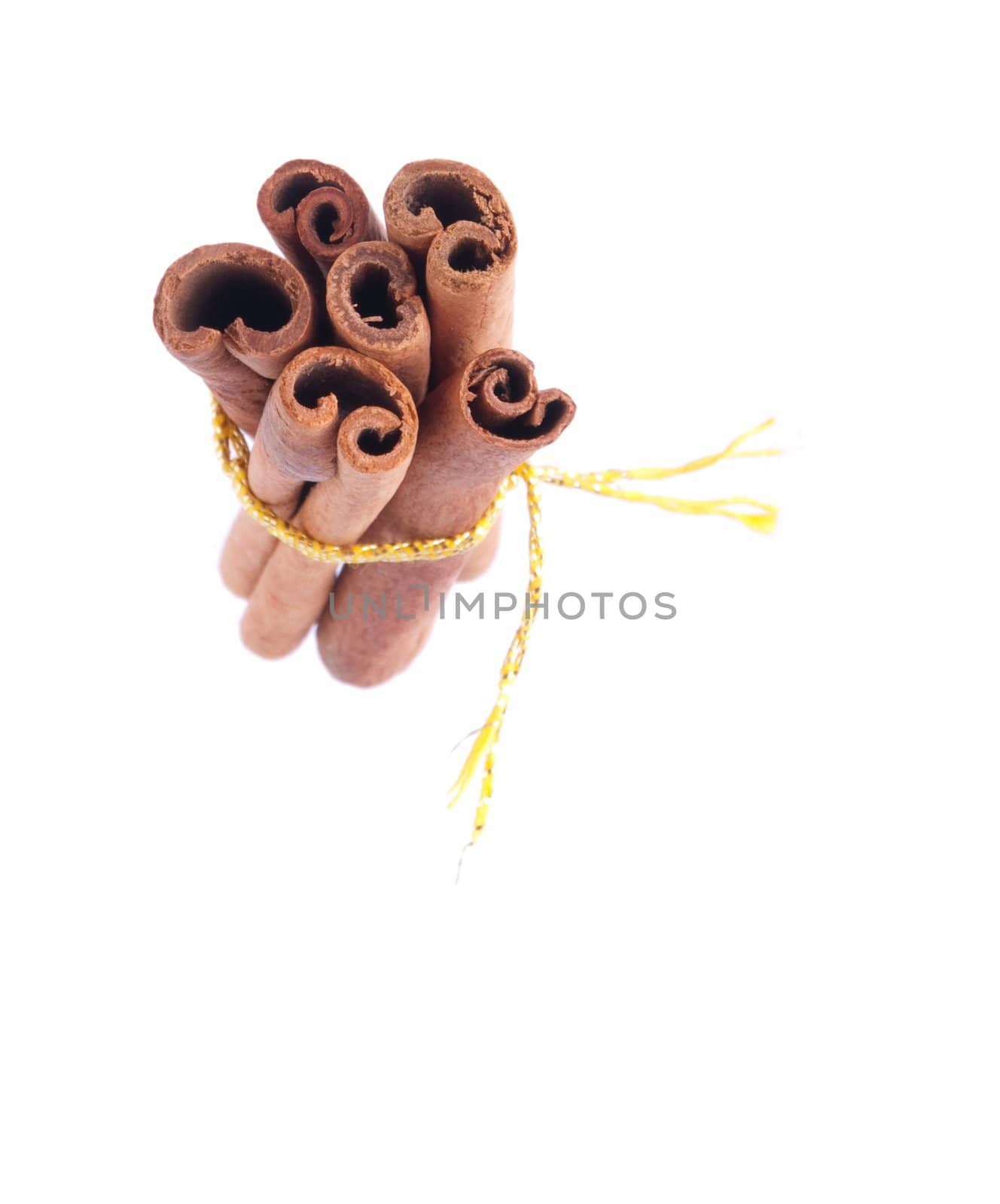 bunch of cinnamon sticks tied by yellow rope (isolated on white background)