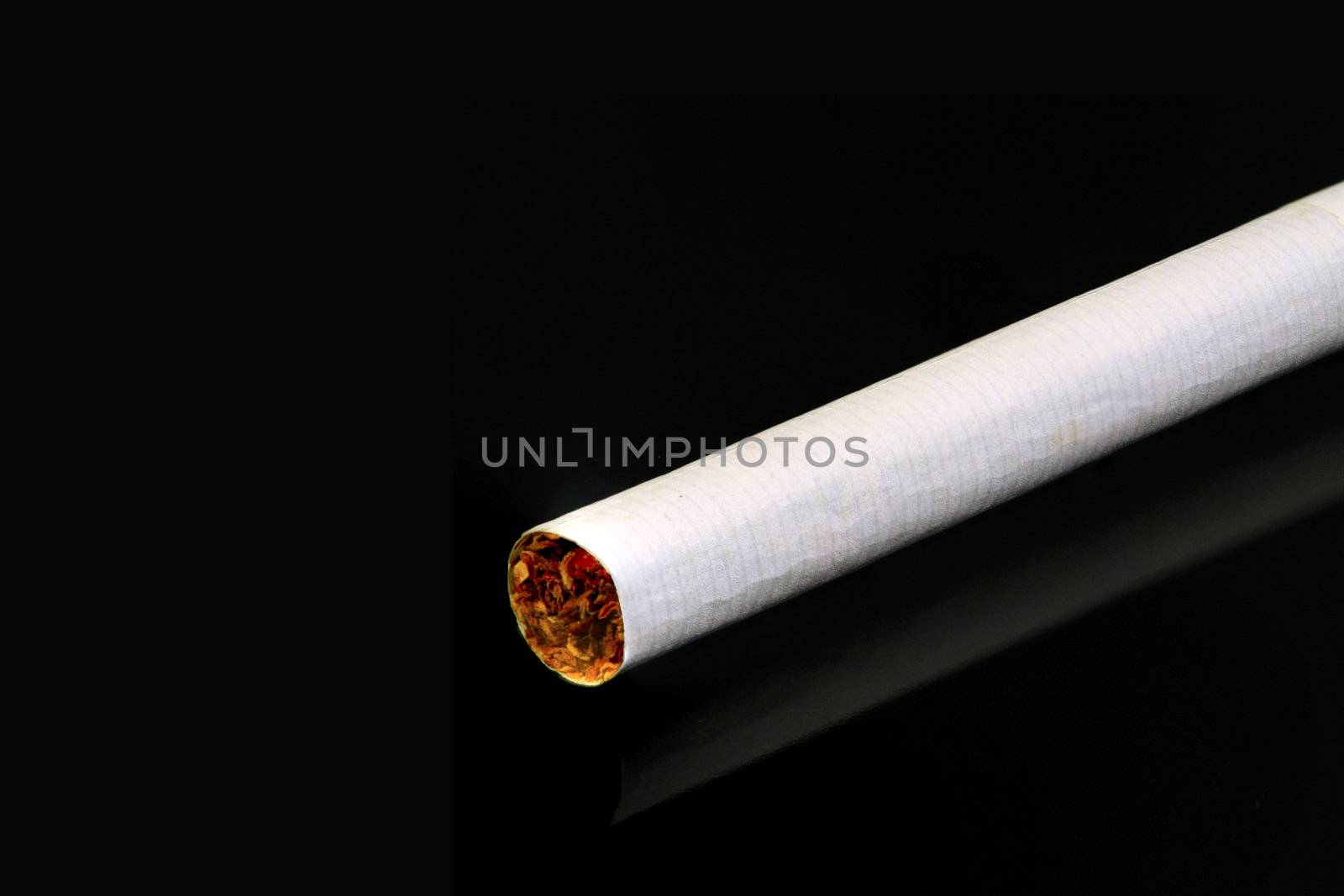 Cigarette isolated on black by ChrisAlleaume