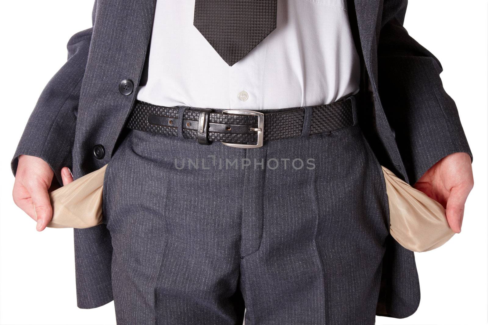 Businessman wearing a tie and showing empty pockets isolated on a white background
