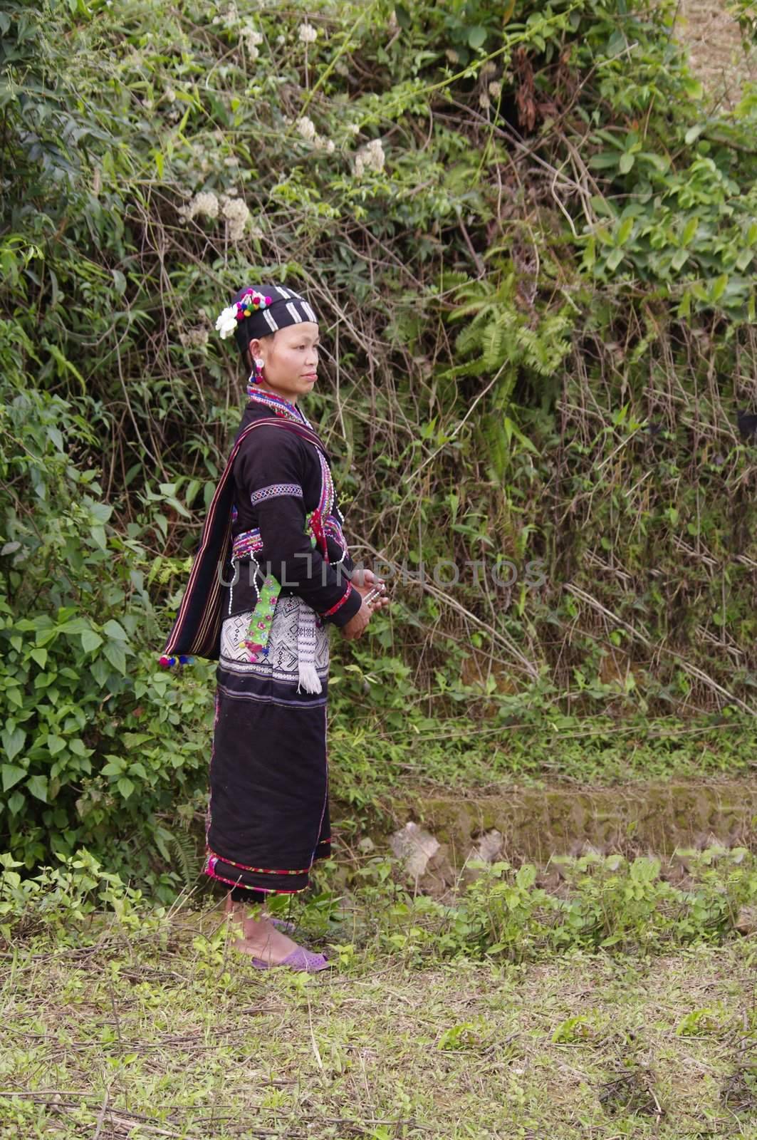 Portrait of a young woman of ethnic LU. She has black teeth, a sign that she is married. She wears her beautiful costumes.