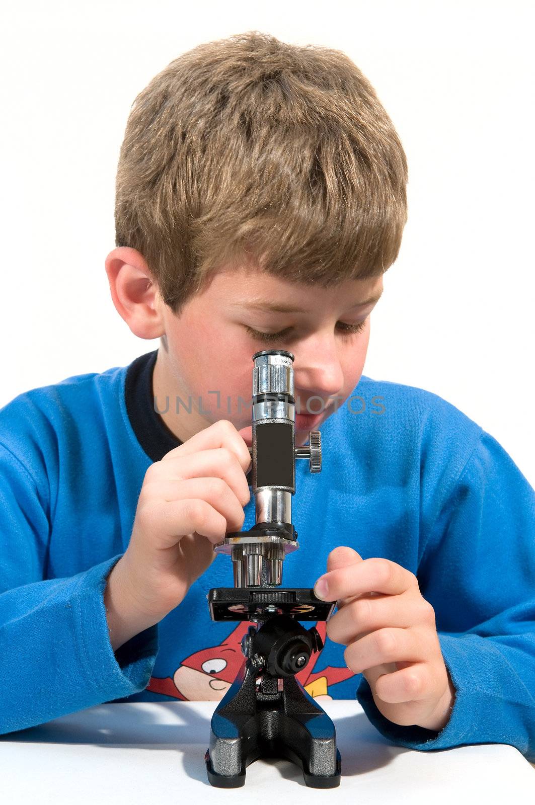 
	
Boy Learning biology considers microscope grain of wheat