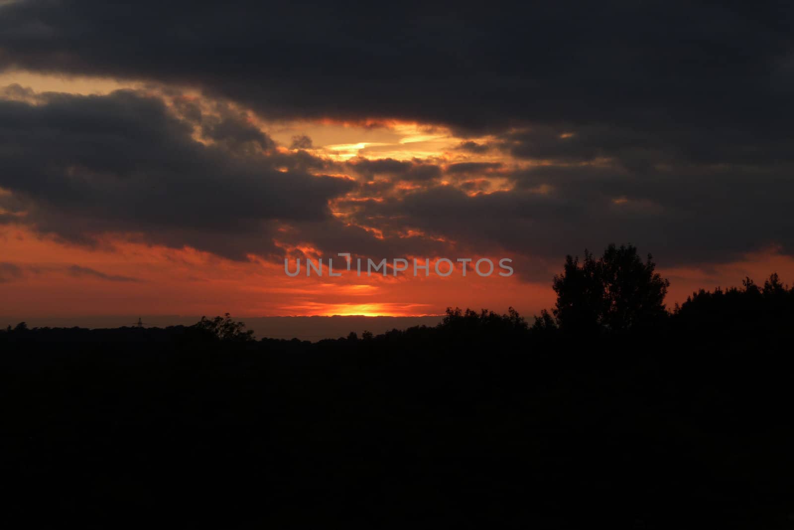 The setting sun over a landscape in Swindon