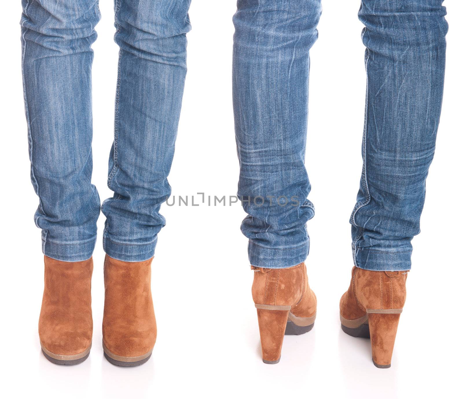 legs in jeans wearing leather fashion boots isolated on white background (front and back posing)