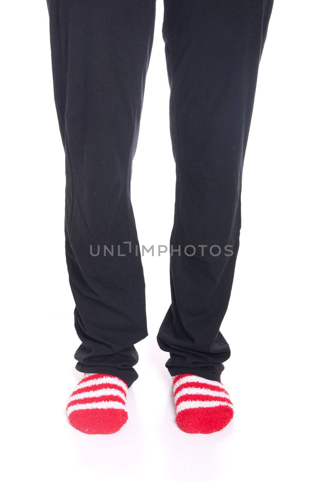 woman legs in pyjamas with red socks on white background