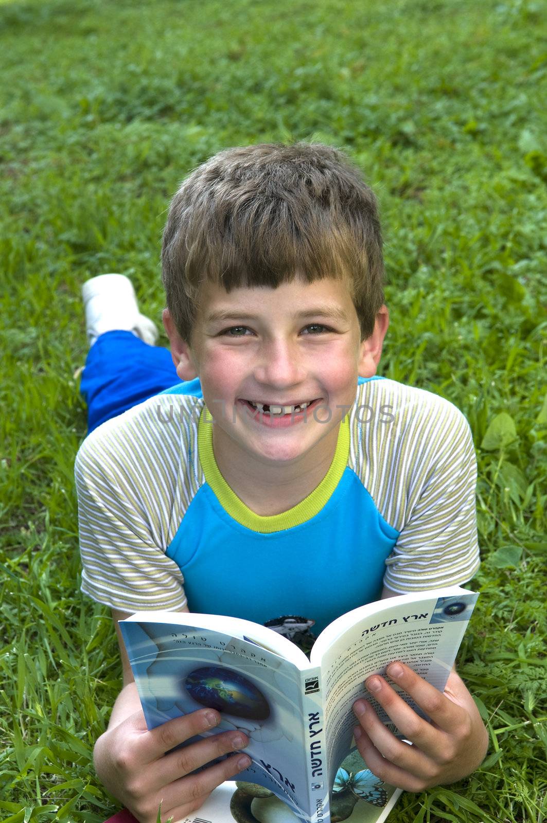 
	
Boy in silence in the garden reading a book