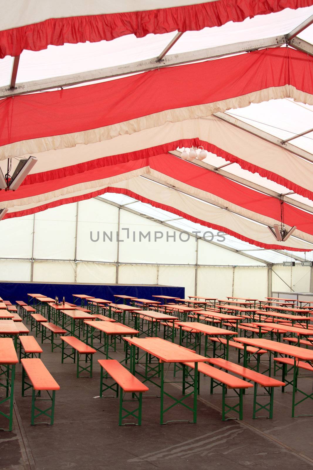 typical folding bench and table sets inside the beer hall at a german fair