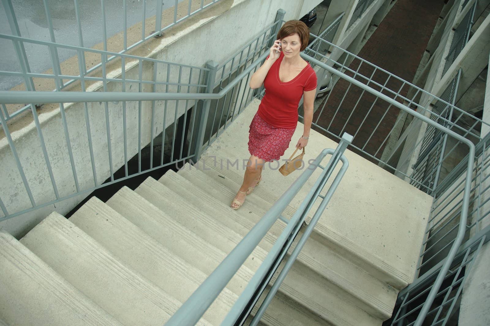 Urban woman walking up stairs.