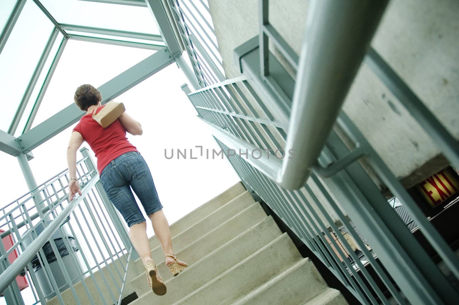 Urban woman walking up stairs.