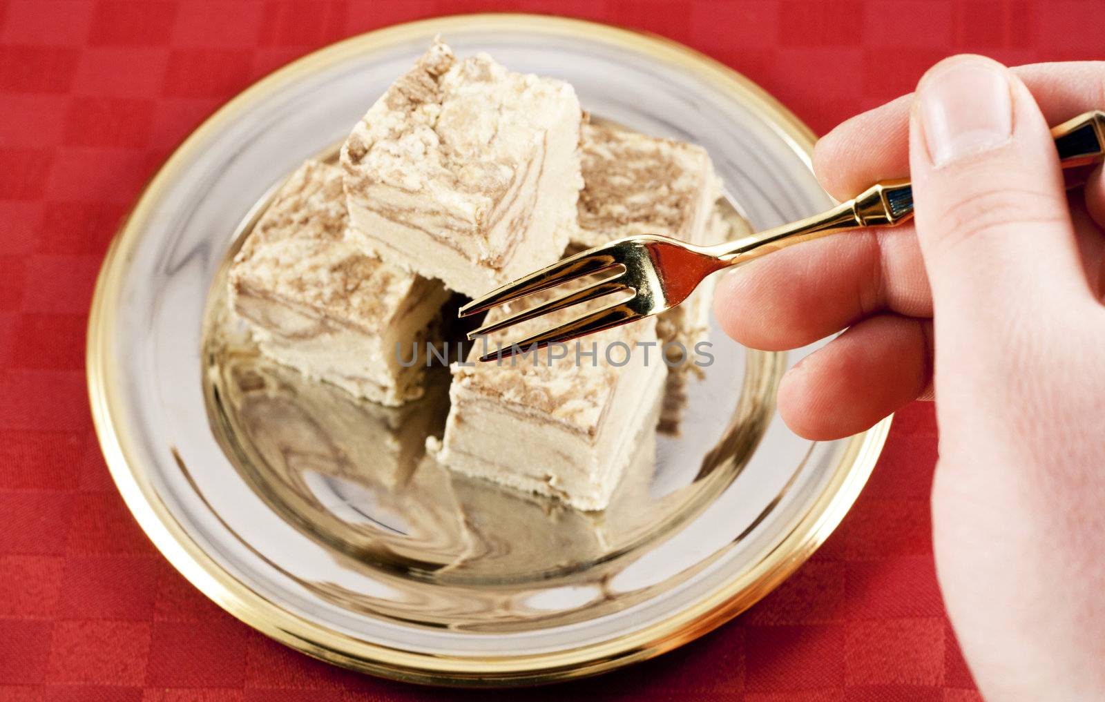 Eating delicious Halva with golden fork