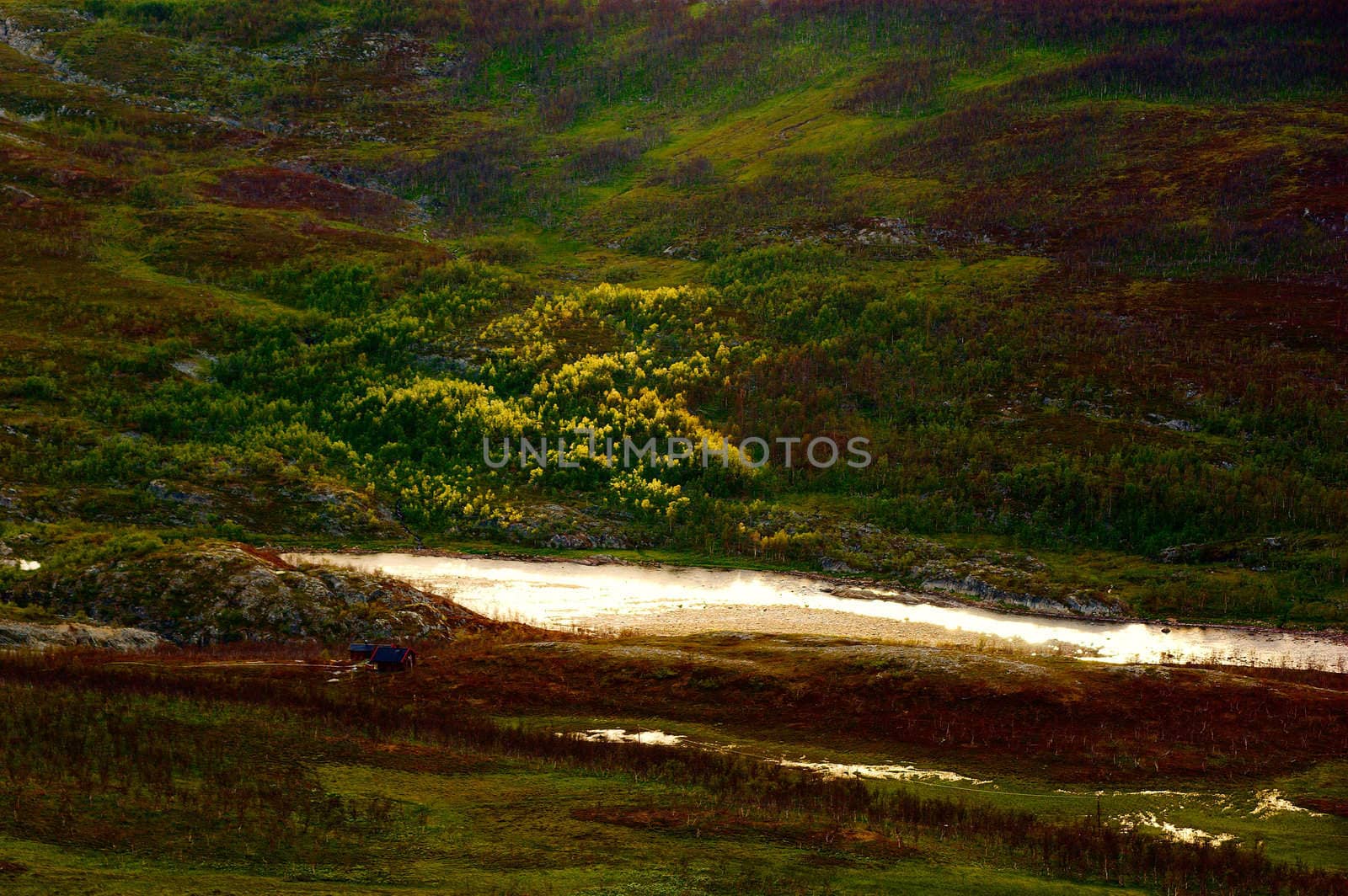 Small house on the coast of the river in the evening, Finnmark, Norway
