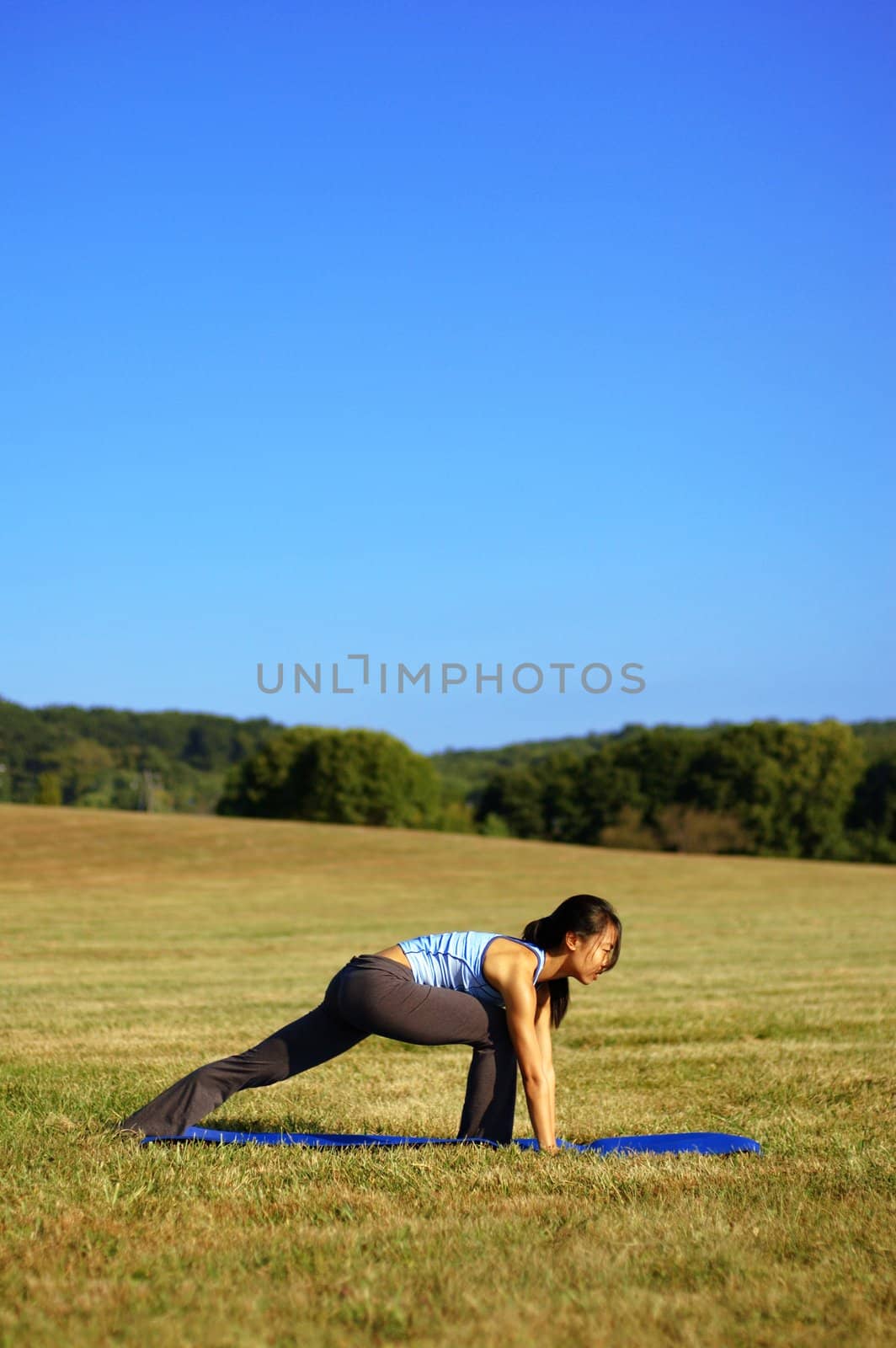 Girl Practicing Yoga In Field by cardmaverick