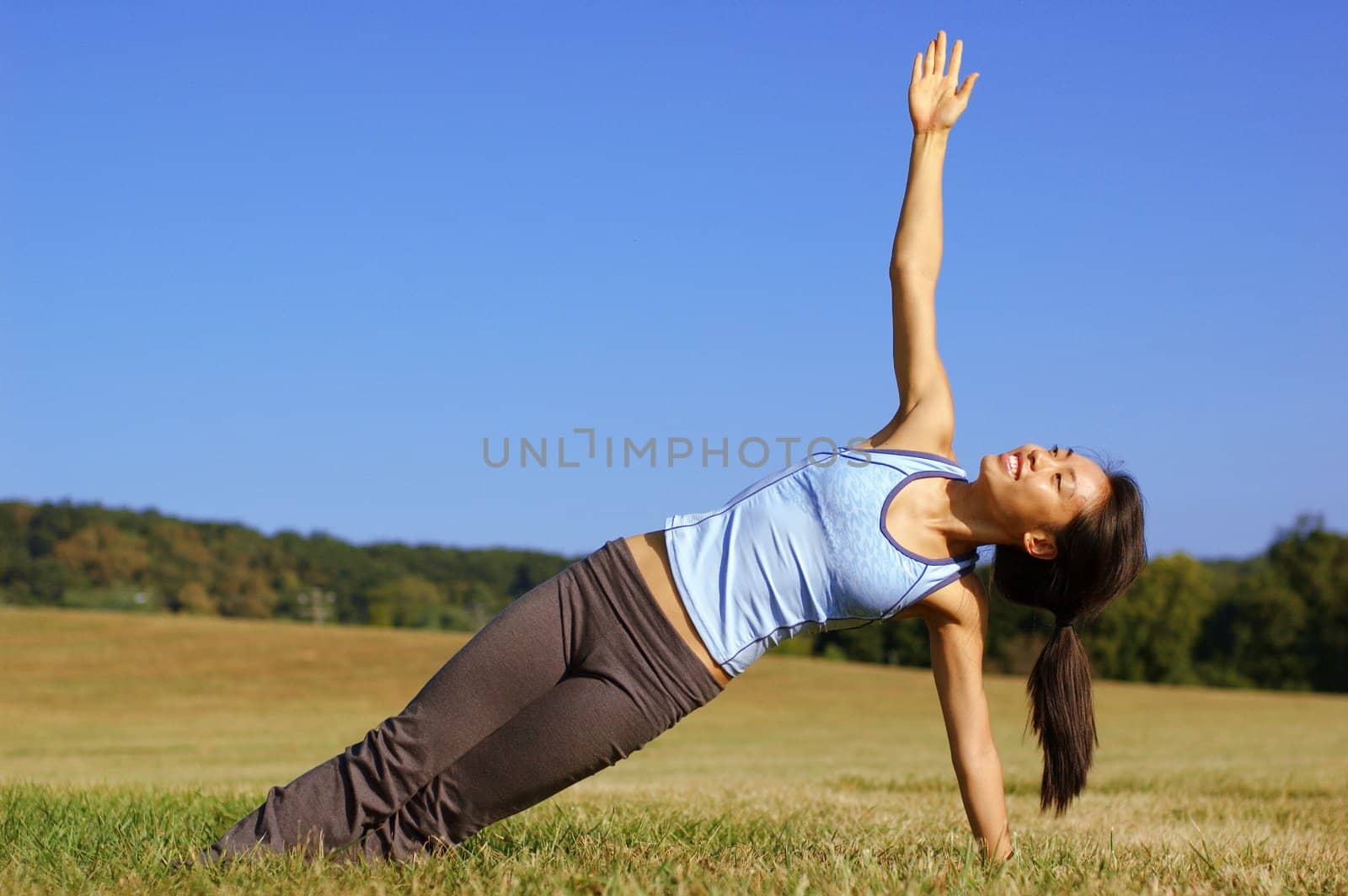 Girl Practicing Yoga In Field by cardmaverick