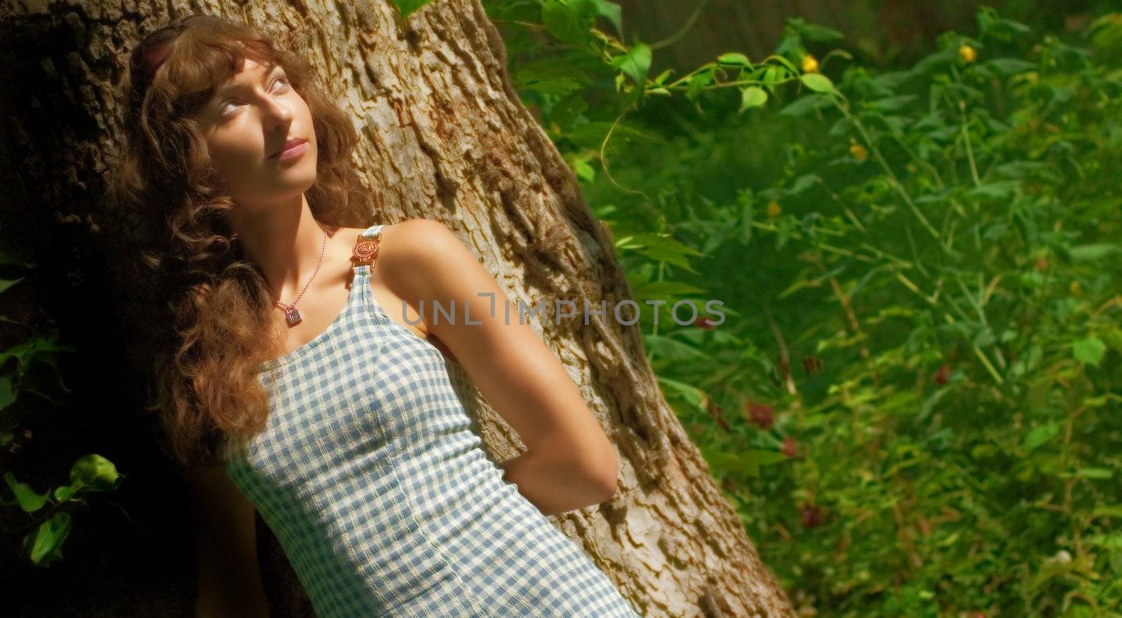 Beautiful woman lounging in the countryside.