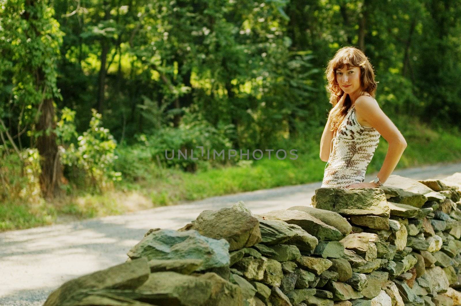 Pretty Girl Next to Stone Fence by cardmaverick
