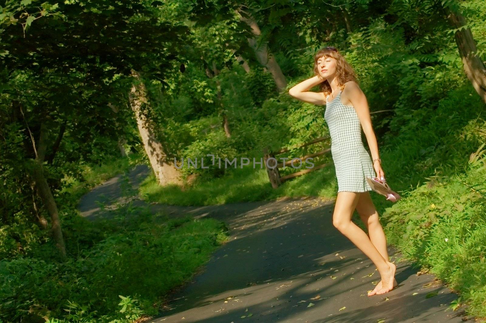 Pretty girl on forested pathway.