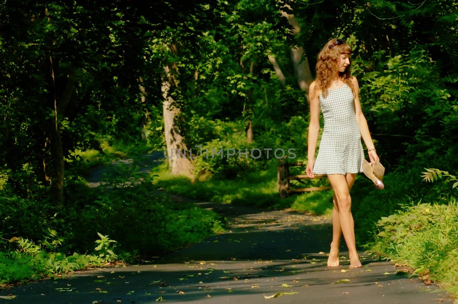 Pretty girl on forested pathway.