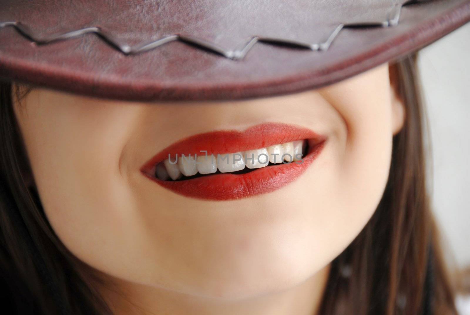 young girl beautiful lips smiling under brown hat