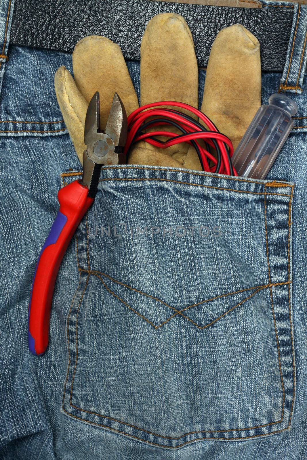 tools in the back pocket of jeans