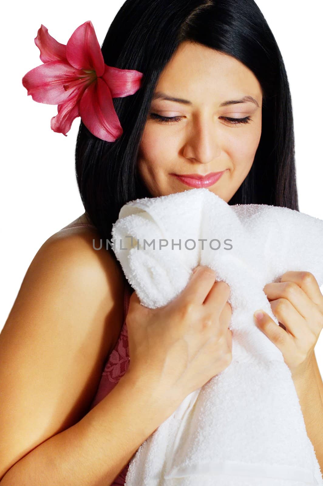 Beautiful young spa woman hugging a white towel.