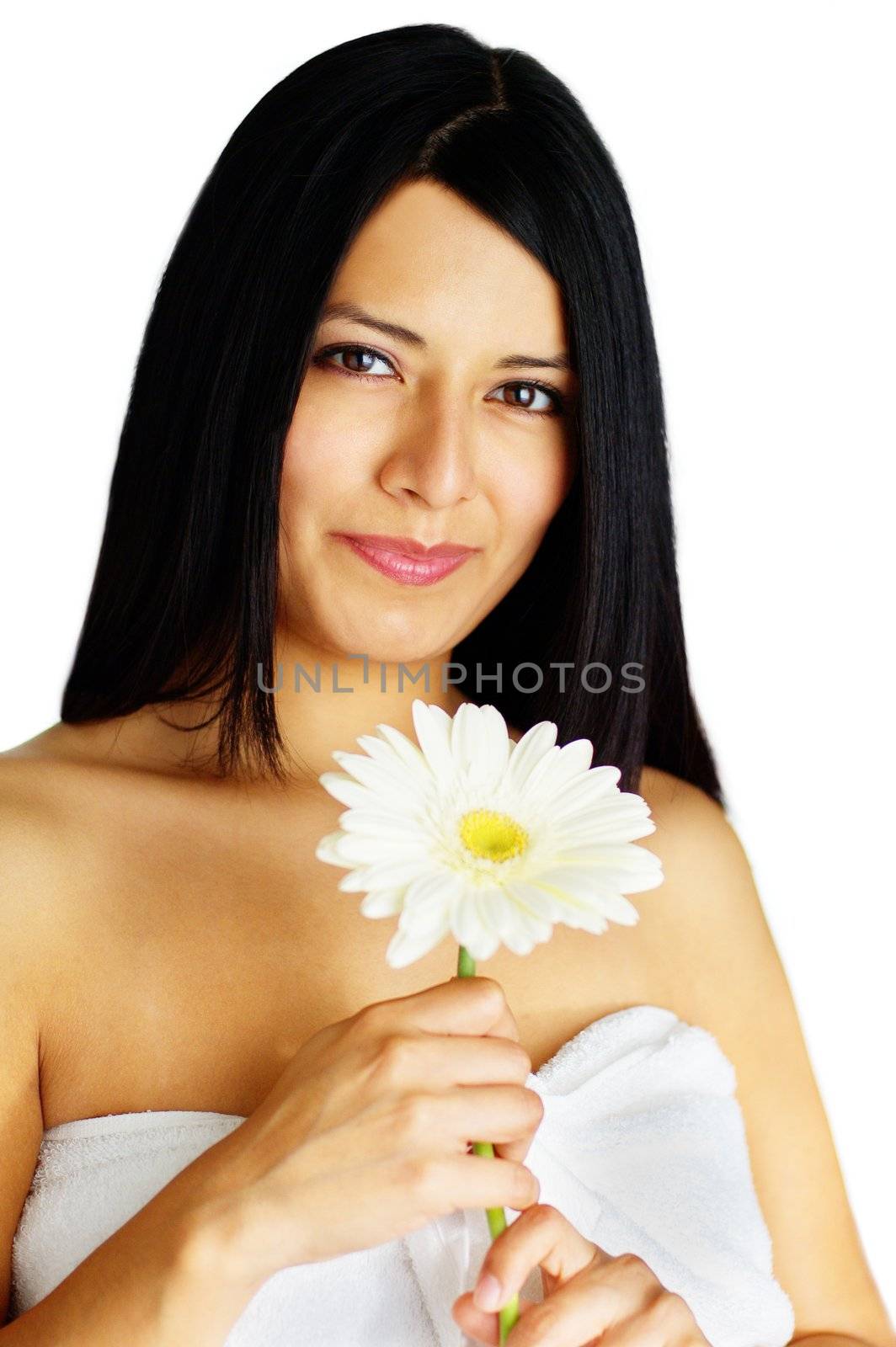 Beautiful young spa woman holding a flower against white.